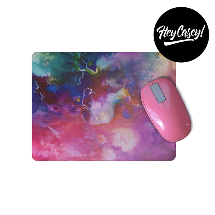 Mouse pad with a marbled design in pinks and blues