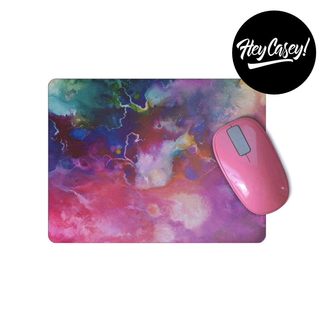 Mouse pad with a marbled design in pinks and blues