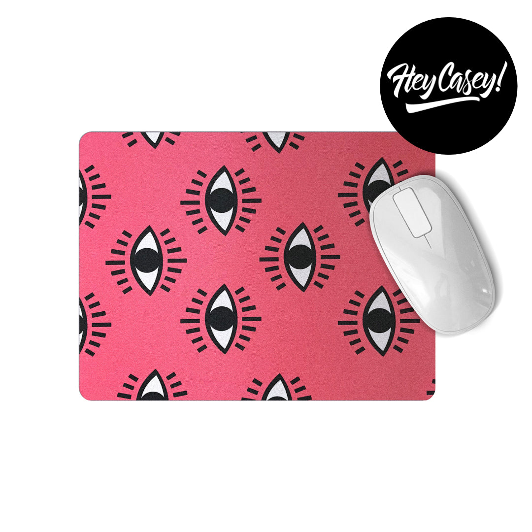 pink mouse pad with black and white eye design