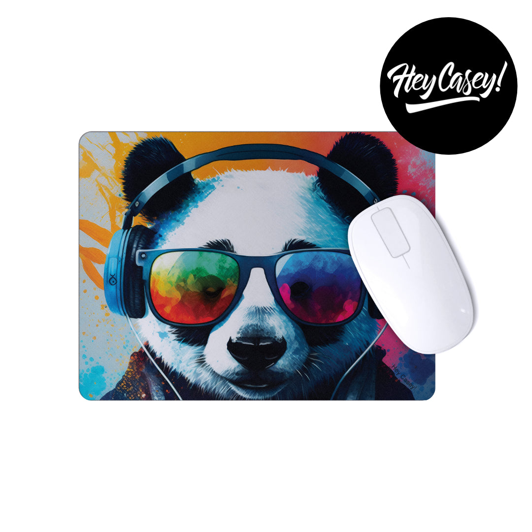A mouse pad with a funky panda wearing sun glasses and headphones