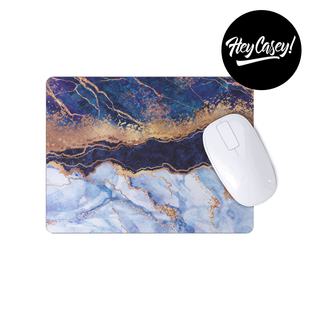 Mouse pad with a quartz like design in blues and gold